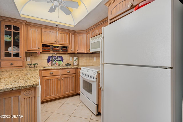 kitchen featuring white appliances, backsplash, ceiling fan, light stone countertops, and light tile patterned floors