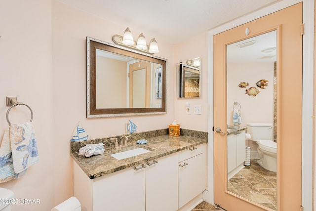 bathroom with vanity and toilet