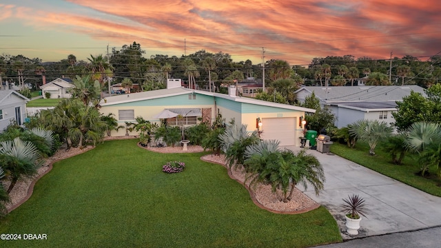 pool at dusk featuring a lawn