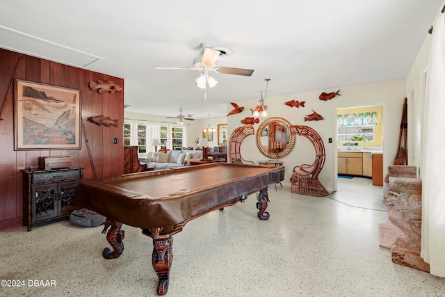 playroom featuring wood walls, ceiling fan, and pool table