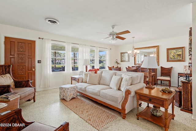 living room featuring ceiling fan with notable chandelier