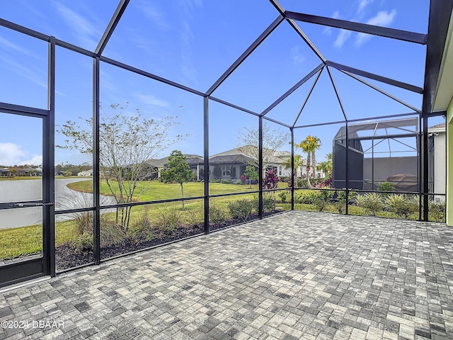 unfurnished sunroom featuring a water view