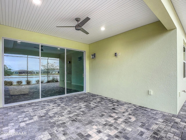 view of patio featuring ceiling fan and a water view