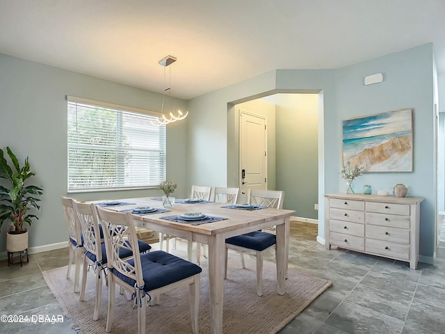 dining area featuring an inviting chandelier