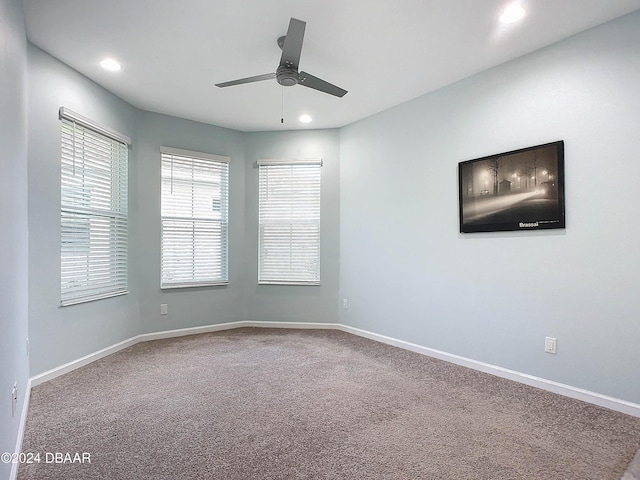 empty room with carpet flooring and ceiling fan