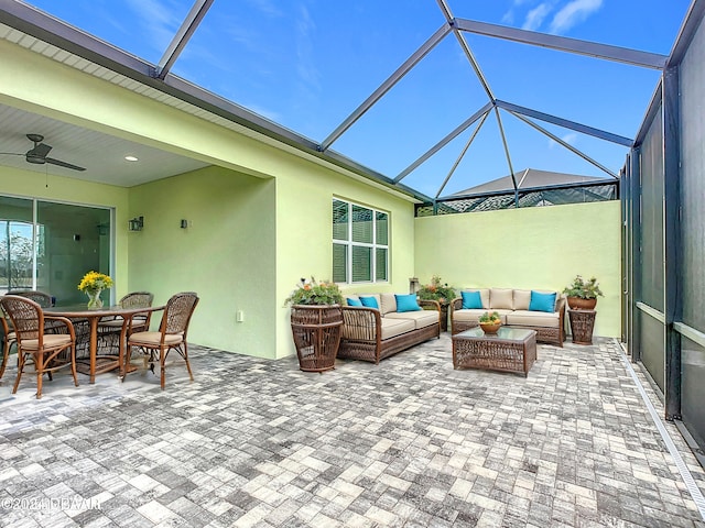 view of patio / terrace featuring outdoor lounge area, ceiling fan, and a lanai