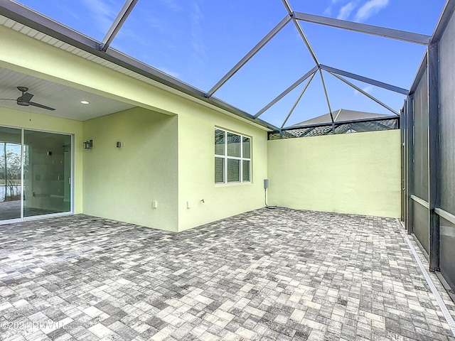 unfurnished sunroom featuring ceiling fan