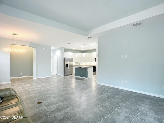 unfurnished living room with sink