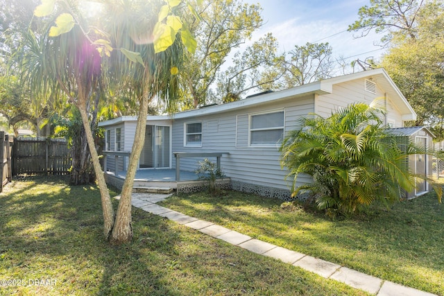 view of front of home with a wooden deck and a front yard