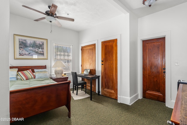 bedroom with a ceiling fan, baseboards, and dark colored carpet