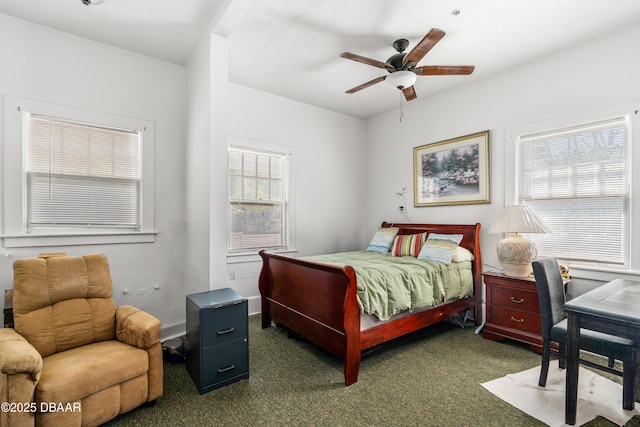 bedroom with a ceiling fan and dark colored carpet