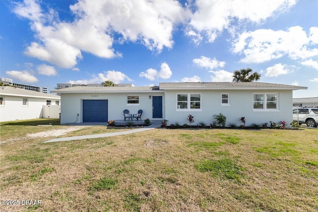 ranch-style house with an attached garage and a front lawn