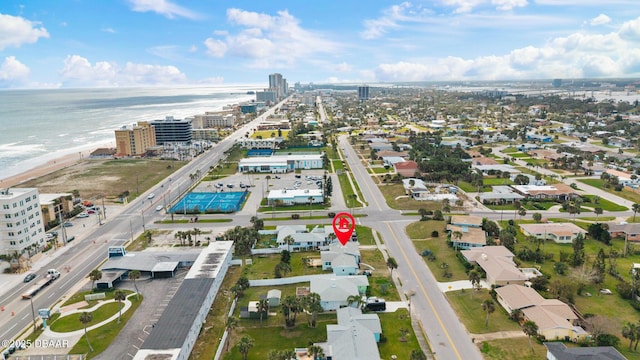 bird's eye view featuring a water view and a beach view