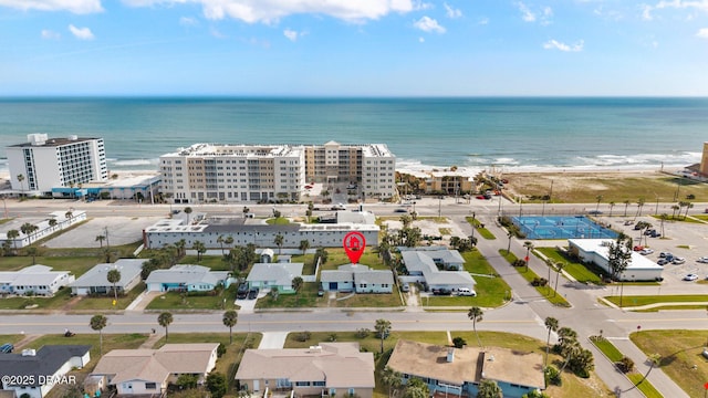 drone / aerial view with a water view and a beach view