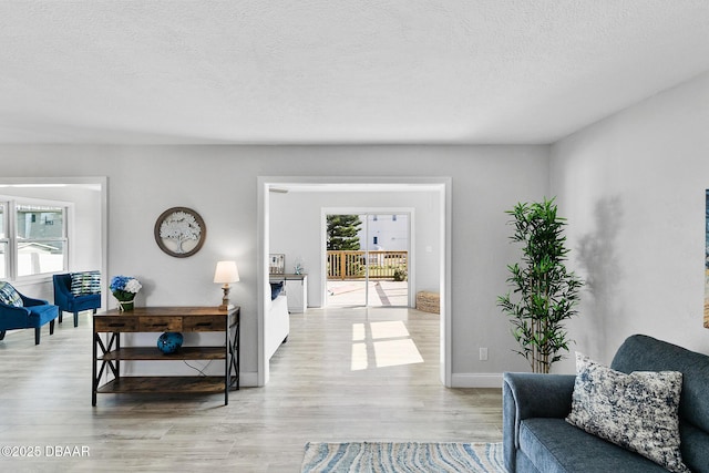 interior space featuring a textured ceiling and light wood-type flooring