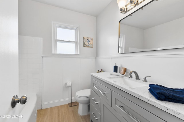 full bathroom with vanity, hardwood / wood-style floors, bathtub / shower combination, and toilet