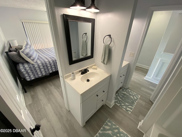 bathroom with vanity and hardwood / wood-style flooring