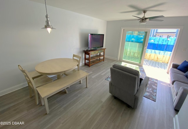 living room featuring hardwood / wood-style floors and ceiling fan