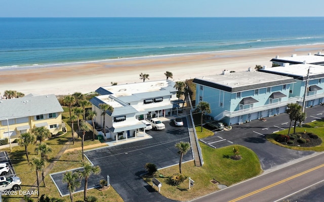 aerial view with a water view and a beach view