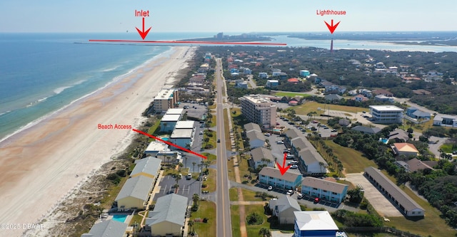 birds eye view of property featuring a beach view and a water view