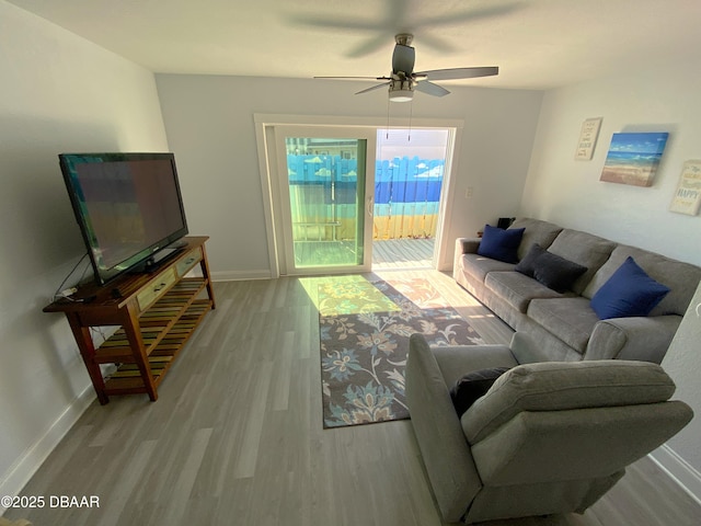 living room featuring ceiling fan and light wood-type flooring