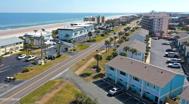 drone / aerial view featuring a water view and a beach view