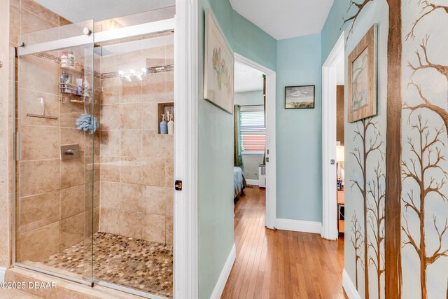 532 Lafayette St, Port Orange, FL 32127 - full bath with wood finished floors, a stall shower, ensuite bathroom, and baseboards