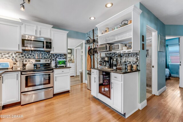 532 Lafayette St, Port Orange, FL 32127 - kitchen featuring stainless steel appliances, beverage cooler, open shelves, white cabinets, and dark stone counters