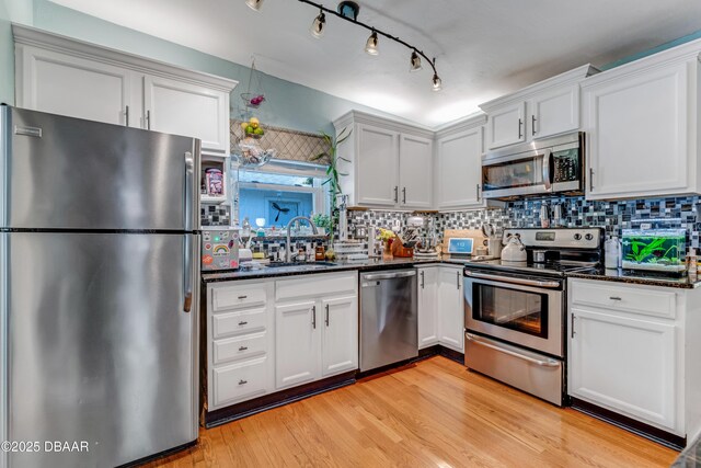 532 Lafayette St, Port Orange, FL 32127 - kitchen featuring appliances with stainless steel finishes, a sink, backsplash, and dark stone counters