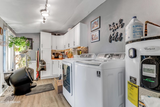 532 Lafayette St, Port Orange, FL 32127 - laundry room with electric water heater, washing machine and dryer, cabinet space, and light wood-type flooring