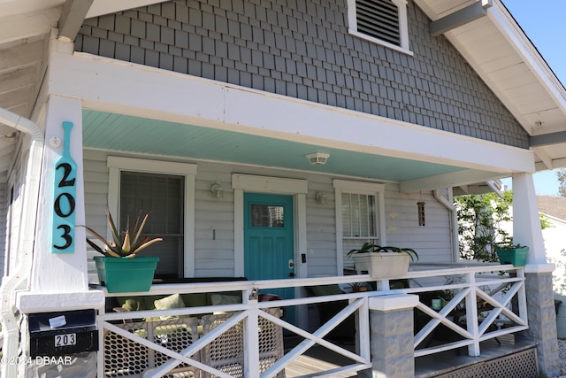 view of exterior entry with covered porch