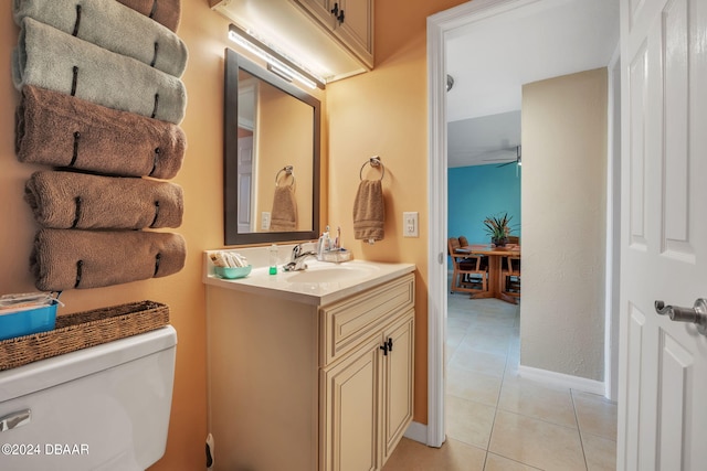 bathroom featuring toilet, vanity, tile patterned floors, and ceiling fan