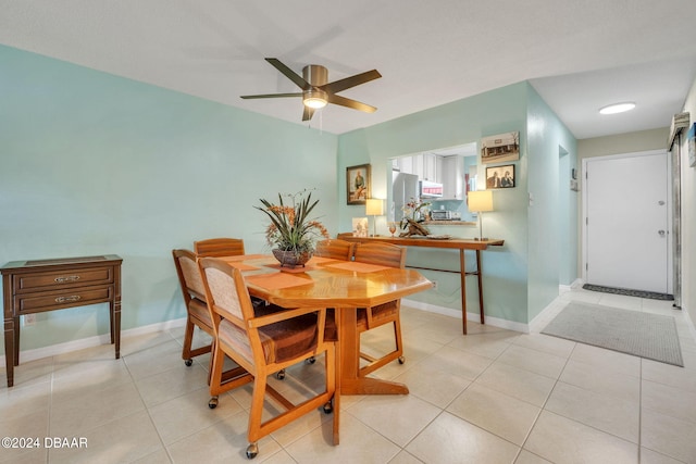 dining space featuring ceiling fan and light tile patterned floors