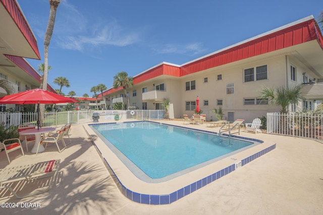 view of swimming pool with a patio