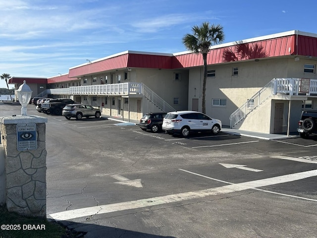 2901 N Halifax Ave Unit 218, Daytona Beach, FL 32118 - view of building exterior featuring stairway and uncovered parking