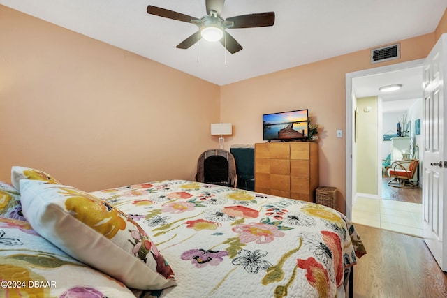 bedroom with ceiling fan and wood-type flooring