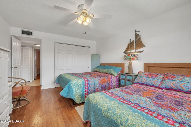 2901 N Halifax Ave Unit 218, Daytona Beach, FL 32118 - bedroom with wood finished floors, a closet, ceiling fan, and a textured ceiling