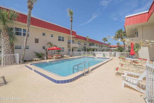 view of swimming pool with a patio area