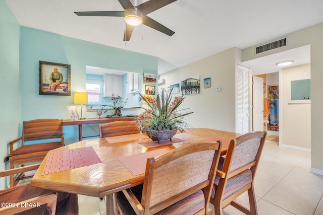 tiled dining space with ceiling fan