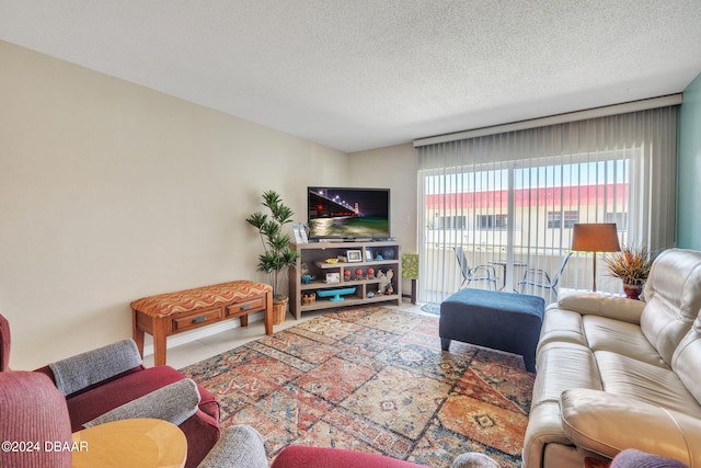 living room featuring tile patterned floors and a textured ceiling