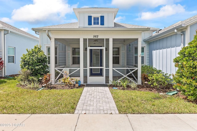 562 Landshark Blvd, Daytona Beach, FL 32124 - property entrance featuring a lawn and board and batten siding