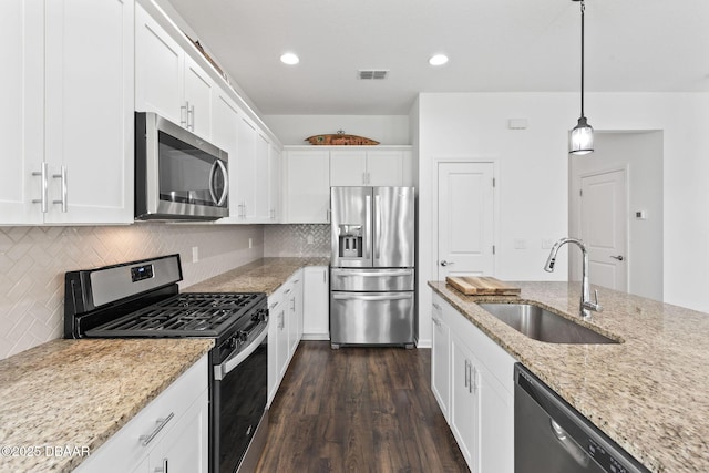 562 Landshark Blvd, Daytona Beach, FL 32124 - kitchen featuring appliances with stainless steel finishes, dark wood-style floors, white cabinetry, light stone countertops, and recessed lighting