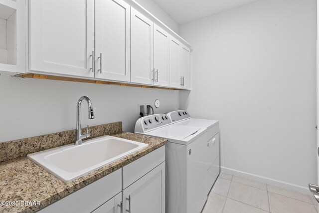 562 Landshark Blvd, Daytona Beach, FL 32124 - washroom with washer and clothes dryer, cabinet space, and light tile patterned flooring