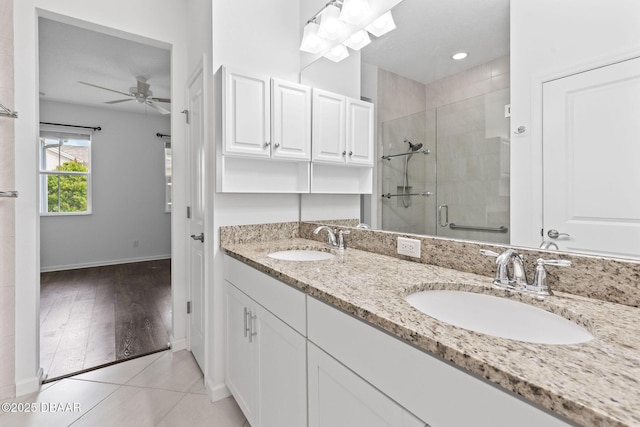 562 Landshark Blvd, Daytona Beach, FL 32124 - full bathroom with a shower stall, double vanity, and a ceiling fan