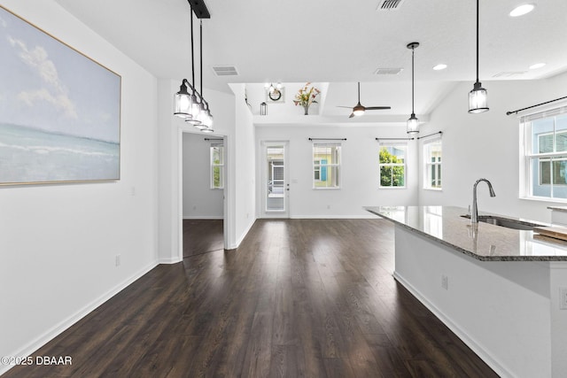 562 Landshark Blvd, Daytona Beach, FL 32124 - kitchen featuring dark wood-style flooring, light stone countertops, recessed lighting, a ceiling fan, and pendant lighting