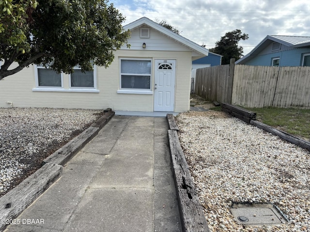 view of front of house featuring fence