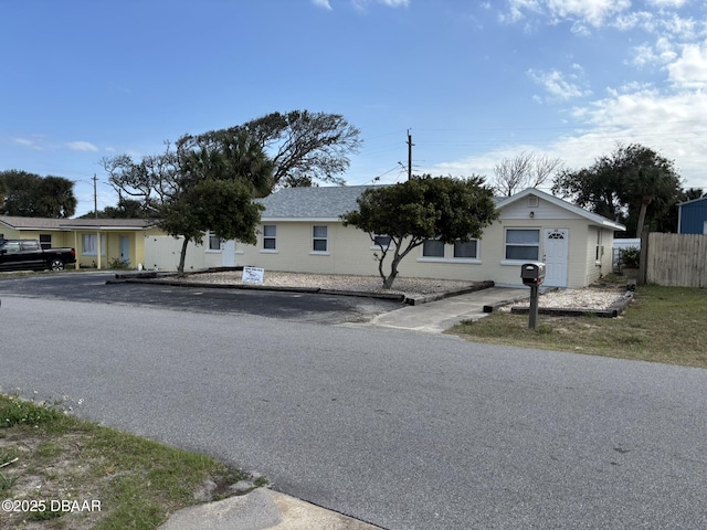 single story home with fence