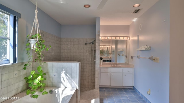 bathroom with visible vents, walk in shower, a bath, tile patterned floors, and vanity