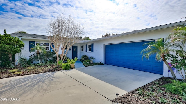 ranch-style home featuring an attached garage and concrete driveway