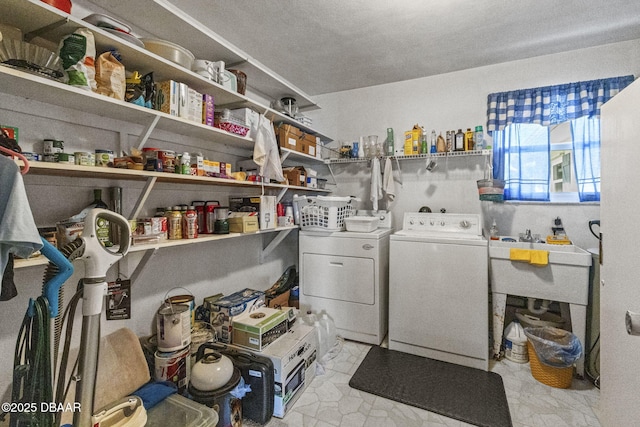 clothes washing area with washing machine and clothes dryer and laundry area